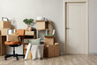 © Pixel-Shot - Workplace with cardboard boxes near light wall in room on moving day
