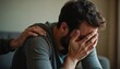 © Vadym - Man overwhelmed by grief receives comforting hand on shoulder support empathy sadness sorrow mental health emotional distress psychological help healing consolation. Person consoles another person.