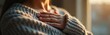 © Vadym - Woman holds hand to chest in moment of quiet reflection. Warm light, soft knit sweater evoke feelings of comfort and inner peace. Self-care and mindfulness.