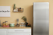 © Pixel-Shot - Interior of kitchen with silver fridge, counters and shelf