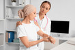 © Pixel-Shot - Mature woman after chemotherapy with doctor in clinic