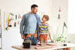 © Pixel-Shot - Happy father and his little son with different instruments assembling stool at home