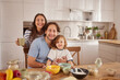 © Stockphotodirectors - A cheerful family spends quality time in a bright kitchen, happily cooking and sharing laughter. The table is filled with ingredients and bowls, creating a warm atmosphere of togetherness.
