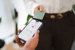 © Studio Marmellata - A person uses a mobile device to make a contactless payment with a credit card, showing a transaction of seventeen dollars and twenty-five cents.
