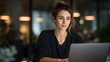 © Sarmin - A young businesswoman working on her laptop in a modern office space