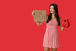 © Pixel-Shot - Young woman with sign GIRL POWER and boxing gloves on red background. Feminism concept