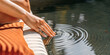 © guguart - Balancing emotions concept and serenity with a gentle touch on the water surface