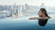 © ronstik - woman enjoying Dubai panorama from rooftop infinity pool. copy space