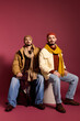 © LIGHTFIELD STUDIOS - Twins showcase stylish attire with a warm color palette in a creative studio setting