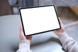 © Farknot Architect - Mockup image of a woman holding digital tablet with blank white desktop screen