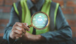 © HappyEva - Engineer holding magnifying glass focusing on safety first and zero accident icons for risk inspection concept, Occupational Health and Safety OHS, EHS Environment, Health, and Safety
