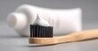 © Studio Nova - The toothbrush with a dollop of white toothpaste on bamboo handle in soft studio light