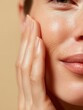 © The Little Hut - Close-up of a Woman's Face with Hand Gently Touching Her Skin, Displaying Natural Beauty and Skincare