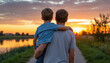 © KseniaJoyg - Rear view of a father carrying his son in his arms on a rural road at sunset, the concept of family well-being and comfort