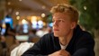 © forenna - Sad portrait of a young man lost in thought, reflecting the internal struggle of gambling addiction with a blurred casino scene behind him. Soft diffused lighting enhances the melancholy atmosphere
