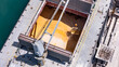 © Emilio - Bulk grain cargo being loaded into ship hold at port terminal.