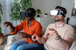 © Marko - People enjoying virtual reality experience in a living room during the afternoon