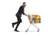 © Ljupco Smokovski - Excited man in a tuxedo running with a full shopping cart