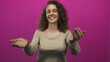 © Krakenimages.com - Young hispanic woman smiling and beckoning with both hands in magenta studio; joyful welcoming invitation.