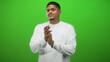 © Krakenimages.com - Man with beard clapping hands in a green screen studio wearing white long sleeve shirt and ring on finger; approval casual content.