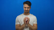 © Krakenimages.com - Young hispanic man in white shirt making expressions against isolated blue background