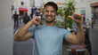 © Krakenimages.com - Young hispanic man smiling on a busy city street with vibrant outdoor atmosphere and urban background