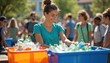 © Maryna - Young woman sorts plastic bottles into recycling bins at outdoor community event. People sort waste for eco friendly initiative, sustainability project, green action.