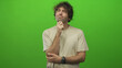 © Krakenimages.com - Man with hand on chin, forearm and watch visible in studio green screen setting; thoughtful contemplation.