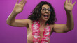 © Krakenimages.com - Middle age hispanic woman in a bikini top and hawaiian lei waves bare arms in a studio; joy celebration enthusiasm.