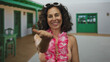 © Krakenimages.com - Middle age woman in bikini with sunglasses on head and pink lei extends her hand toward camera in sunlit courtyard; invitation warmth.