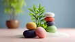 © Nataliia_Trushchenko - A collection of colorful stones are arranged on a table in front of a potted plant. The stones are of various sizes and colors, creating a visually appealing and calming scene