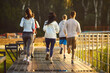 © Studio Romantic - Running group of young athletes jogging marathon in park, healthy outdoor fitness workout of male and female runners. People training, building stamina in cardio exercises, enjoying sport in nature