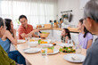 © Kawee - Asian loving family spending quality time, having dinner in cozy house.