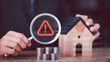 © chaylek - Financial analyst evaluating mortgage risk and housing uncertainty with warning symbol, Business of interest rate volatility, loan risk management, financial caution, real estate market analysis
