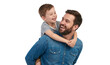 © The Stock Guy - Happy father smiling and carrying his son with care, isolated on white background. PNG