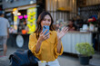 © Laingzaifa - Asian women enjoy delicious street food at night markets, smiling throughout their vacation, exploring the city's culture, vibrant lights, and fun-filled adventures.