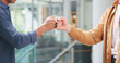 © peopleimages.com - Business people, handshake and friends with fist bump for social connection and b2b networking. Coworking, collaboration and hands in meeting with synergy, solidarity or welcome to team for inclusion
