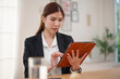 © eggeeggjiew - Asian businesswoman using tablet working at home office