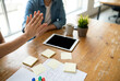 © Debi Kurnia Putra - Business Colleagues Giving High Five At Desk During Meeting