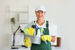 © Pixel-Shot - Female janitor with cleaning supplies in office