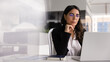 © fizkes - Serious mature businesswoman, company head, reviewing financial report, marketing strategy seated at table with laptop, horizontal image. Professionalism, modern, innovative AI tech usage in business