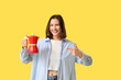 © Pixel-Shot - Beautiful young woman pointing at geyser coffee maker on yellow background