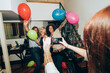 © Westend61 - Woman photographing friends dancing during party at home