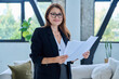 © Valerii Honcharuk - Portrait of middle-aged confident businesswoman with business papers