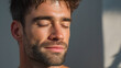 © Marut - Young man with eyes closed and subtle glow on face in warm spa tones, relaxed expression and soft natural light