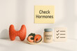 © Chanita - Minimal medical scene for thyroid health awareness. Check hormones reminder with gland model, seafood, iodized salt, and checklist. concept for diet and wellness
