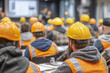 © Thanthara - Construction workers attending training course indoors wearing safety helmet and reflective vest, focused on learning in classroom setting with blurred background
