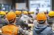 © Thanthara - Construction workers wearing safety helmet attending industrial safety seminar in conference room with blurred presentation screen and speaker in background