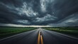 © Asawin - A long straight road under a stormy sky, leading towards the horizon