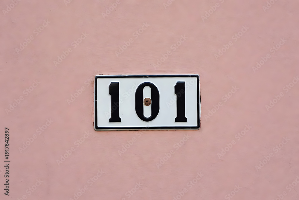 House number sign with black numbers 101 on white background, attached ...